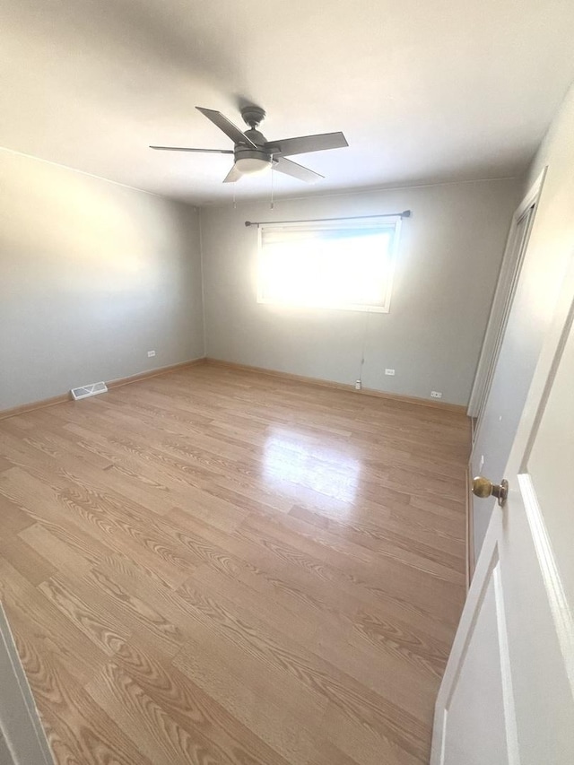 spare room with ceiling fan and light hardwood / wood-style flooring