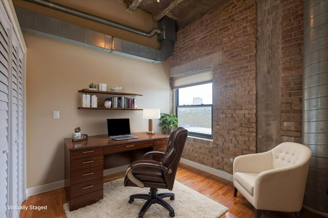 2545 S Dearborn St Unit 508, Chicago, IL 60616 - office featuring brick wall, baseboards, wood finished floors, and a high ceiling