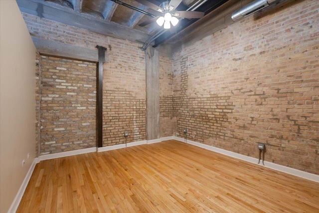 2545 S Dearborn St Unit 508, Chicago, IL 60616 - basement featuring wood-type flooring, baseboards, brick wall, and ceiling fan