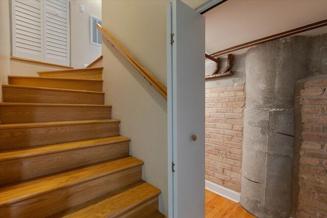 2545 S Dearborn St Unit 508, Chicago, IL 60616 - stairs with wood finished floors and brick wall