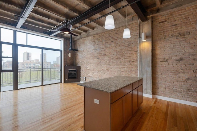 2545 S Dearborn St Unit 508, Chicago, IL 60616 - kitchen with light wood-style flooring, baseboards, brick wall, wood ceiling, and beam ceiling
