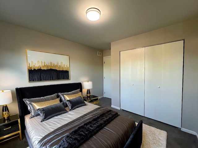 bedroom with dark carpet and a closet