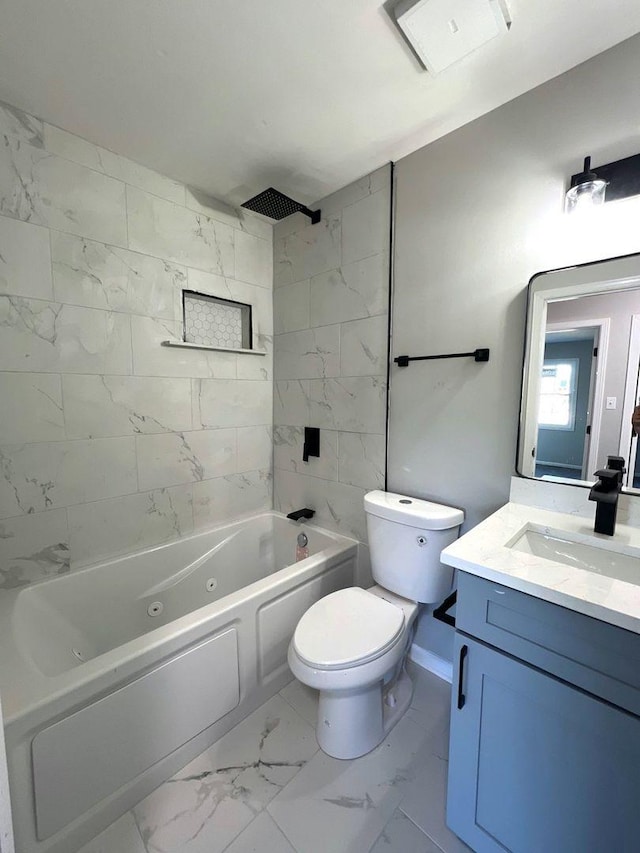 full bathroom featuring toilet, tiled shower / bath combo, and vanity