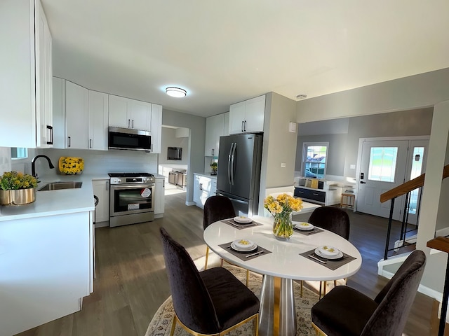 dining space with sink and dark hardwood / wood-style floors