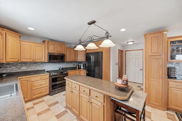 kitchen with pendant lighting, appliances with stainless steel finishes, light brown cabinets, and tasteful backsplash