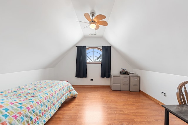 bedroom with ceiling fan, light hardwood / wood-style floors, and lofted ceiling