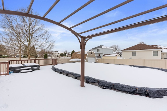 yard layered in snow with a pergola