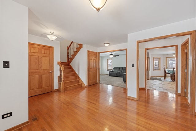 foyer entrance with light wood-type flooring and a healthy amount of sunlight