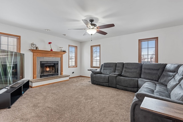 living room with a fireplace, carpet floors, a wealth of natural light, and ceiling fan