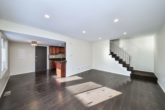 unfurnished living room with sink and dark hardwood / wood-style flooring