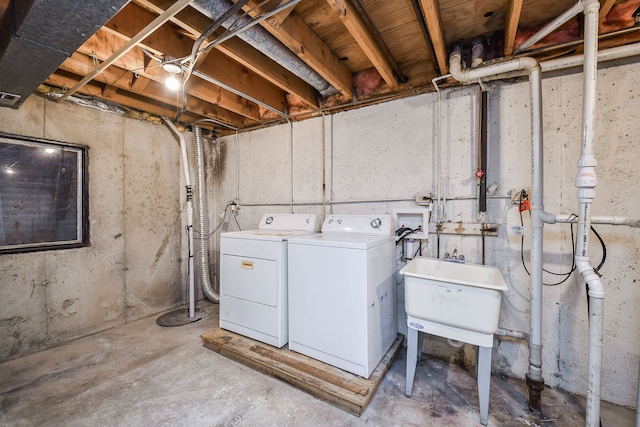 laundry room with washing machine and clothes dryer and sink