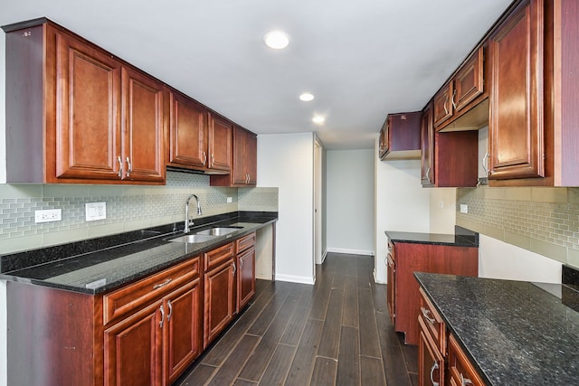 kitchen featuring sink, dark stone counters, and decorative backsplash