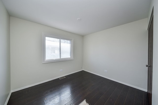 spare room with dark wood-type flooring