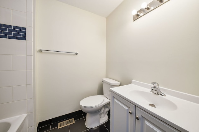 bathroom with tile patterned flooring, vanity, and toilet