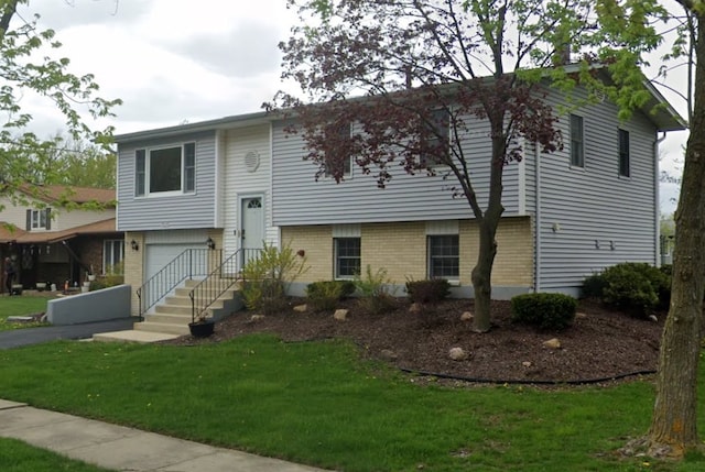 bi-level home with a front lawn and a garage