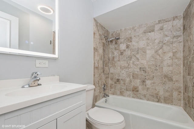 full bathroom with toilet, vanity, and tiled shower / bath