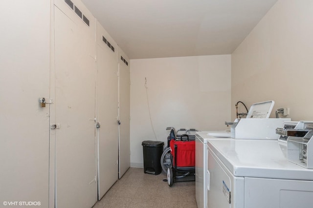 clothes washing area featuring washer and dryer