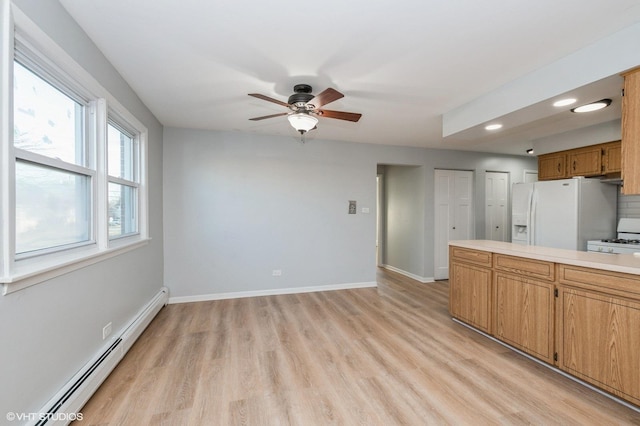 kitchen with a baseboard radiator, white fridge with ice dispenser, range, ceiling fan, and light hardwood / wood-style flooring