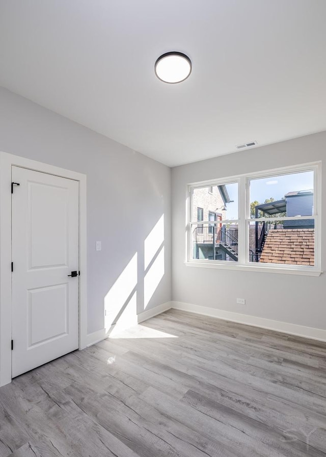 spare room with light wood-type flooring