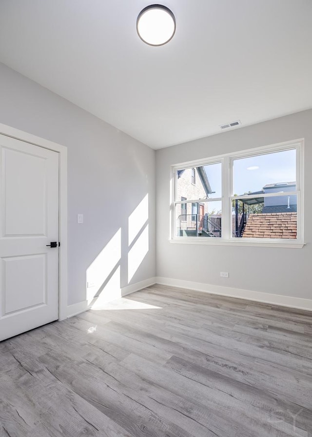 empty room with light hardwood / wood-style floors