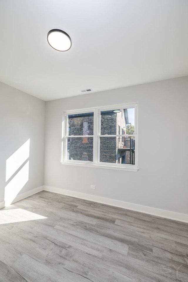 unfurnished room featuring light hardwood / wood-style floors