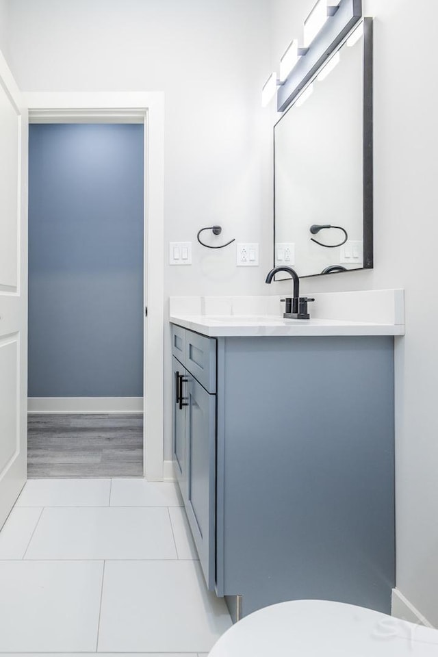 bathroom featuring toilet, tile patterned flooring, and vanity