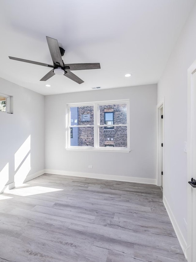 spare room with ceiling fan, light hardwood / wood-style flooring, and a wealth of natural light