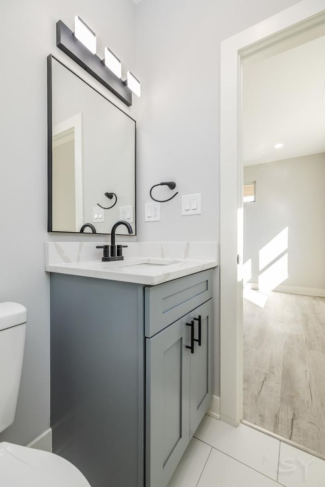 bathroom featuring toilet and vanity