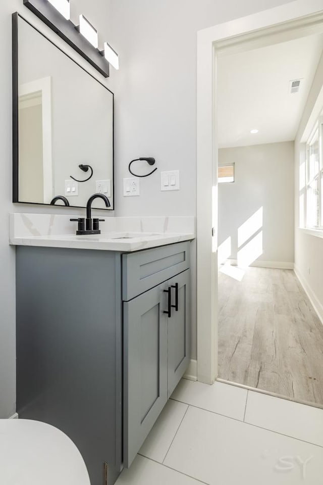 bathroom with toilet, tile patterned flooring, and vanity