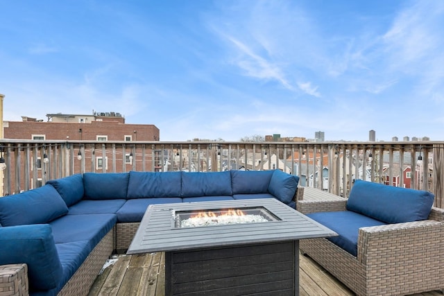 deck featuring an outdoor living space with a fire pit