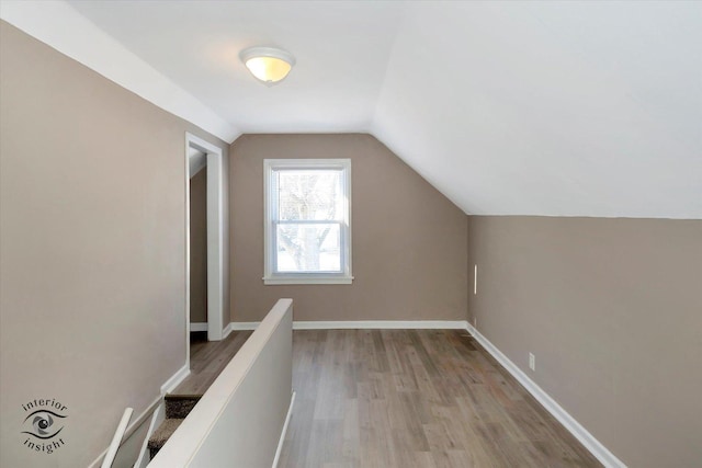 bonus room with light hardwood / wood-style flooring and lofted ceiling