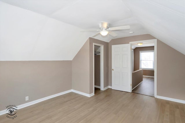 bonus room featuring ceiling fan, vaulted ceiling, and light wood-type flooring