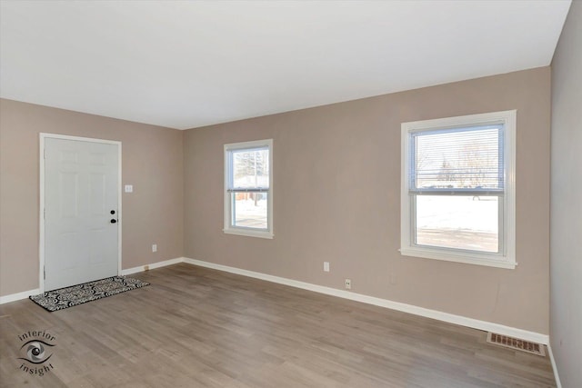 spare room with light hardwood / wood-style floors