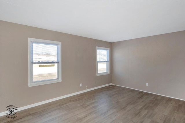 spare room with hardwood / wood-style flooring