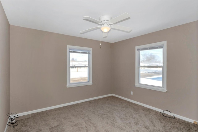 empty room with ceiling fan and light carpet