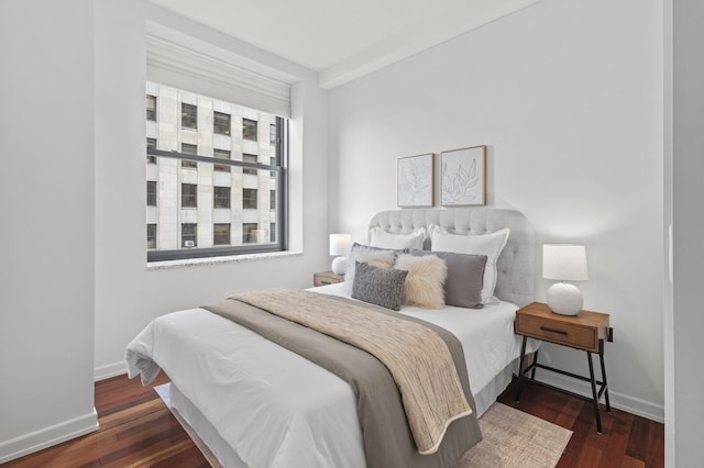 bedroom with dark wood-type flooring