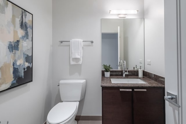 bathroom featuring toilet, tile patterned floors, and vanity