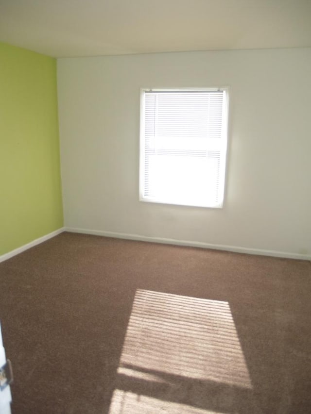 empty room featuring dark carpet