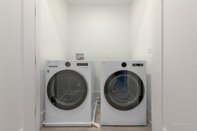 laundry area with independent washer and dryer