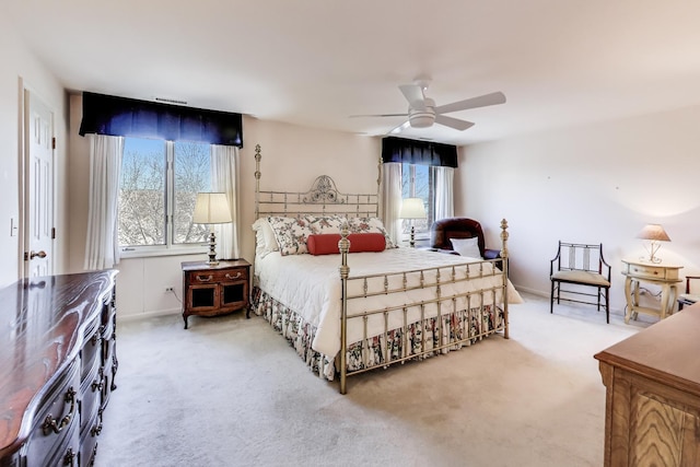 bedroom featuring ceiling fan and carpet