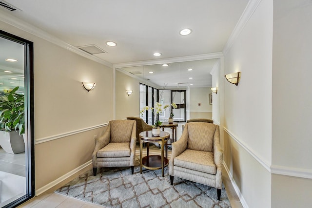 sitting room featuring light tile patterned floors and crown molding