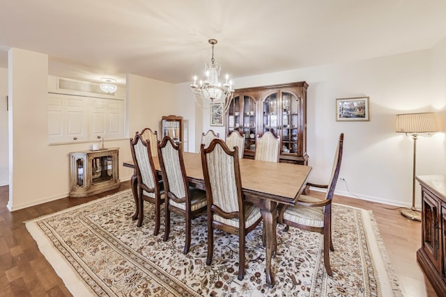 dining room featuring hardwood / wood-style flooring and a notable chandelier