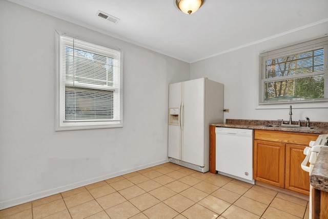 kitchen featuring sink, white appliances, light tile patterned flooring, and ornamental molding