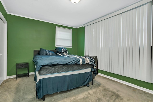 bedroom with crown molding and carpet