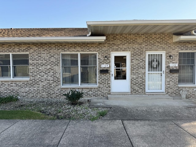 view of exterior entry featuring a patio area