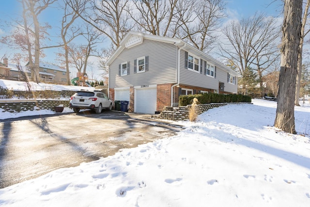 view of snow covered exterior with a garage