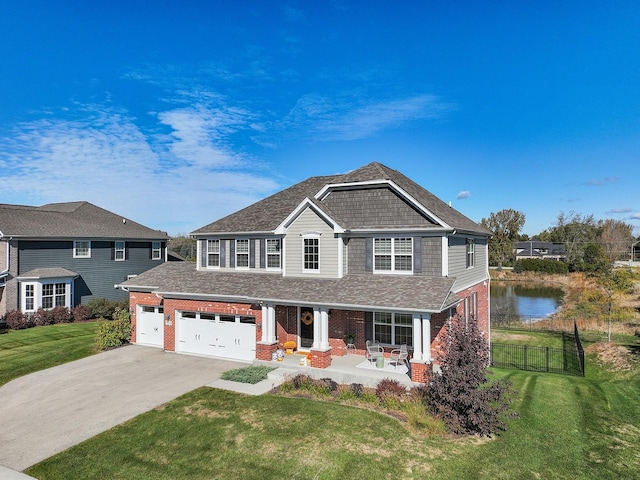 view of front of property with a water view, a porch, and a front lawn