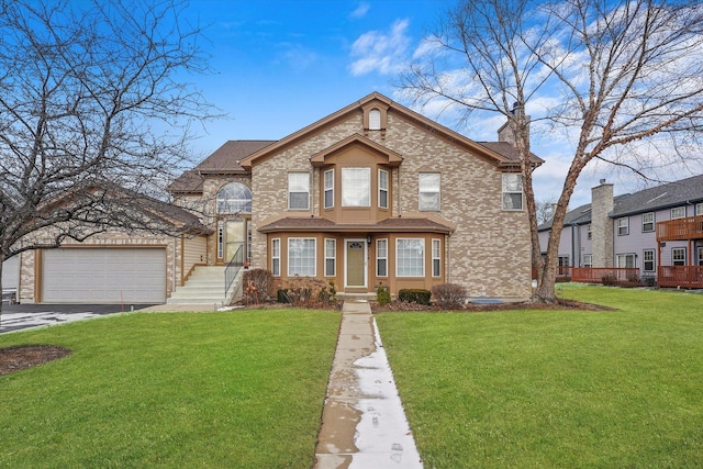 view of front of house featuring a garage and a front lawn