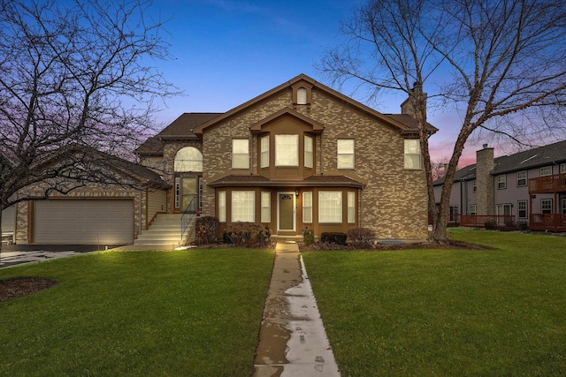 view of front of home featuring a lawn and a garage