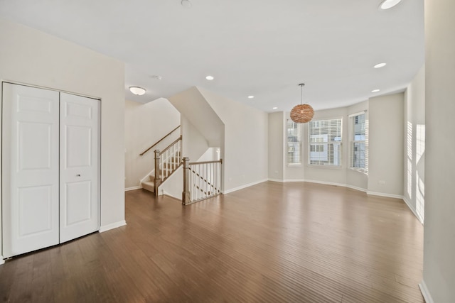 unfurnished living room with dark wood-type flooring